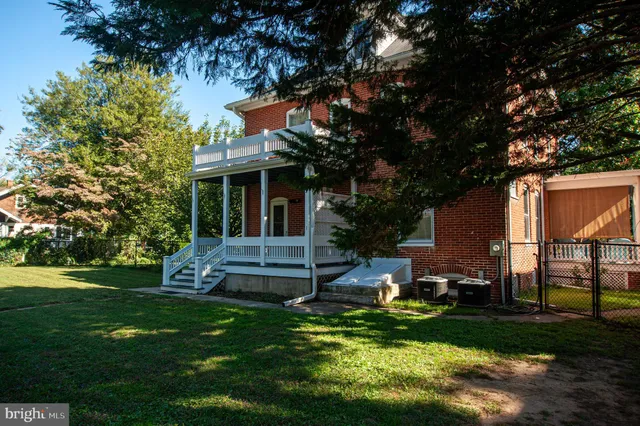 a view of a porch with chairs and backyard