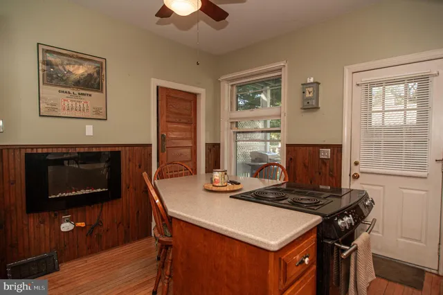 a view of a room with wooden floor benches and windows
