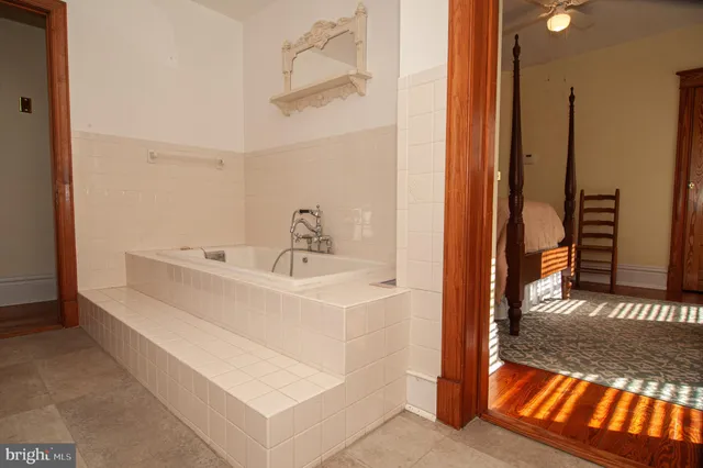 a living room with furniture a piano and a flat screen tv