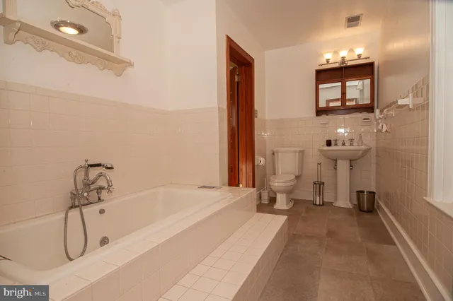 a living room with furniture a rug and a fireplace