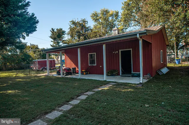 a view of a house with a yard porch and sitting area