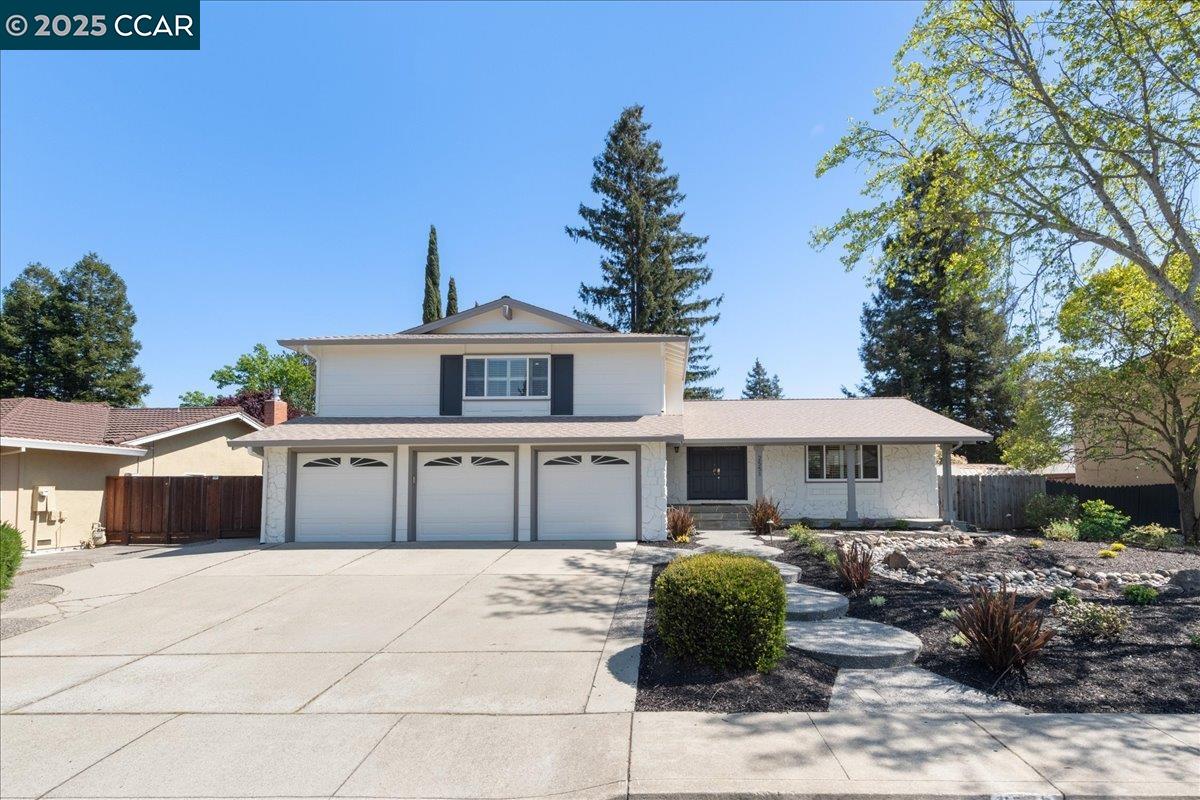 a front view of a house with a garden