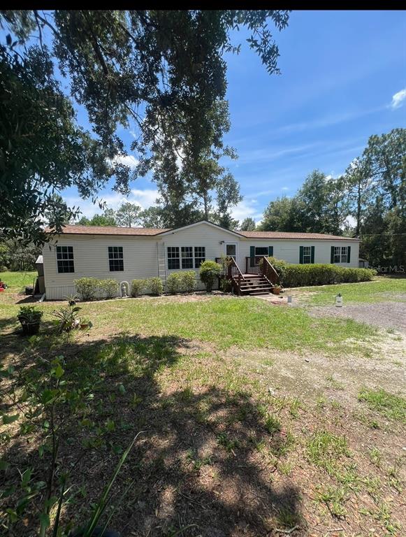a view of a house with a big yard