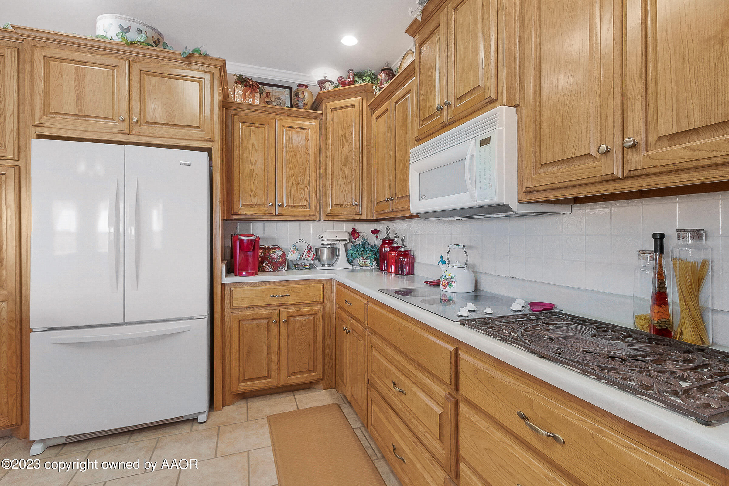 5895 West W Dumas, TX 79029 - Photo 19 of 43 a kitchen with granite countertop cabinets and white appliances