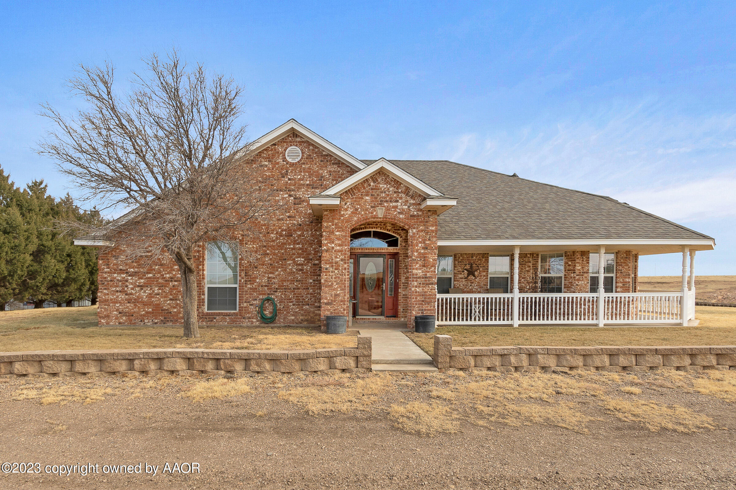 5895 West W Dumas, TX 79029 - Photo 5 of 43 a front view of a house with a yard