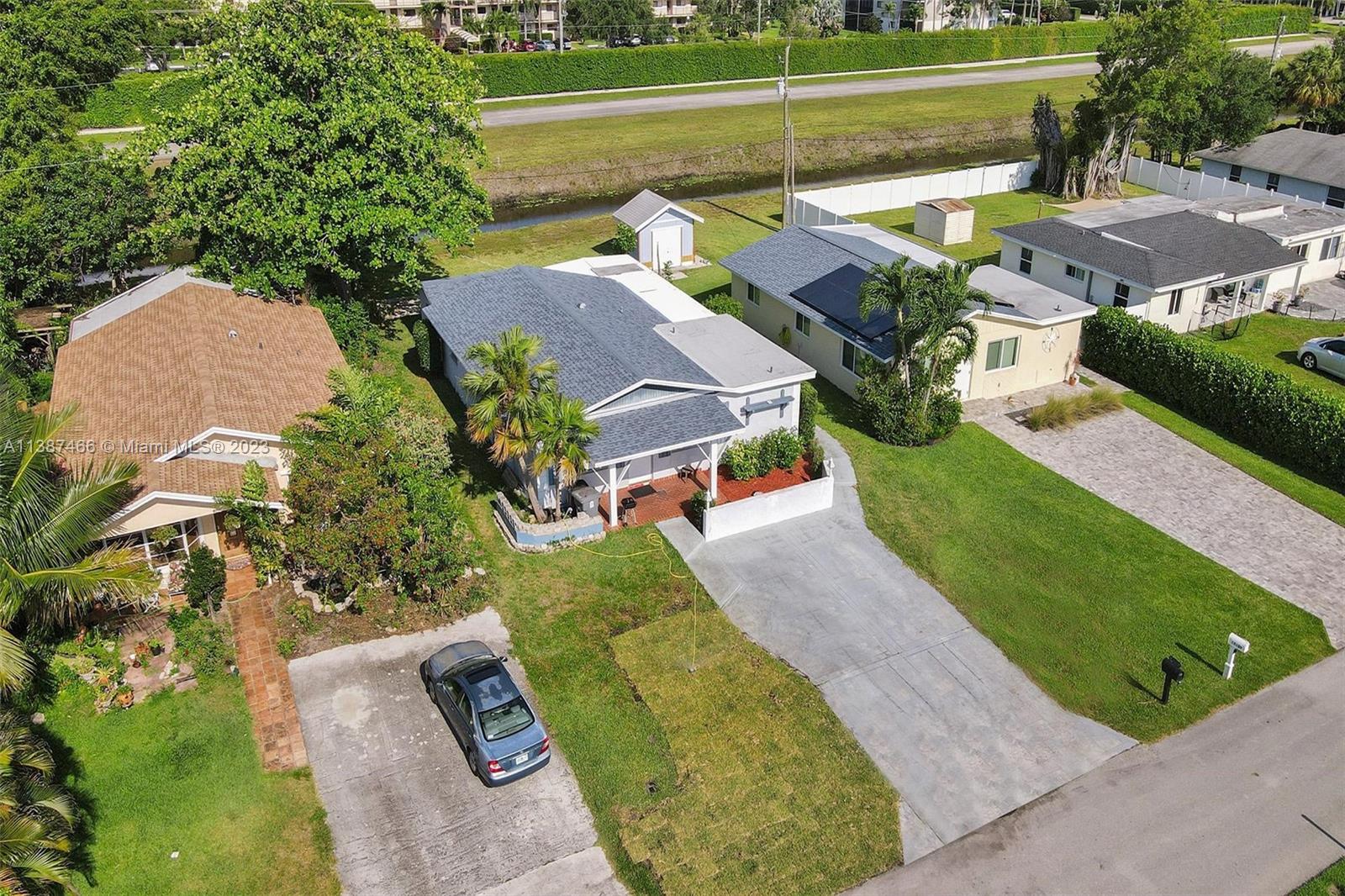 15119 Jackson Road Delray Beach, FL 33484 - Photo 54 of 80 an aerial view of a house with a garden and swimming pool