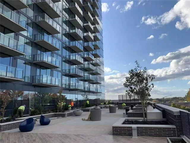 a view of a patio with couches and potted plants