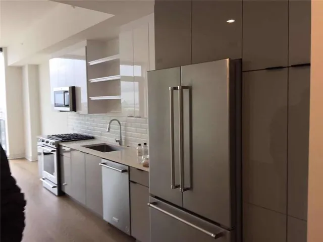 a kitchen with stainless steel appliances a refrigerator stove and sink