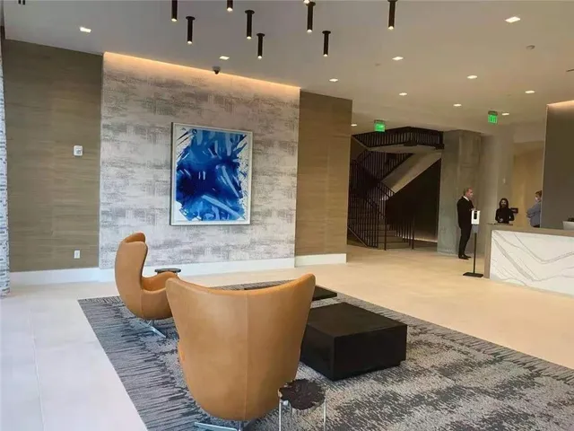 a lobby with a couch and a potted plant