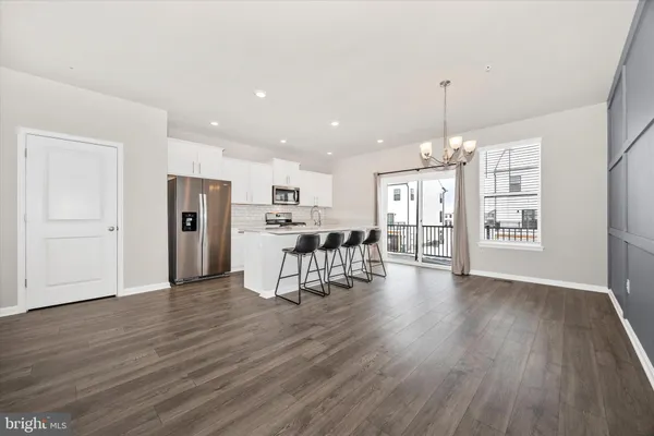 a view of an empty room with a kitchen