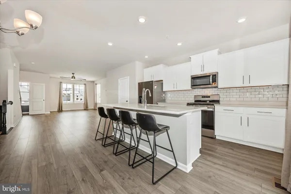 a kitchen with a sink cabinets and wooden floor
