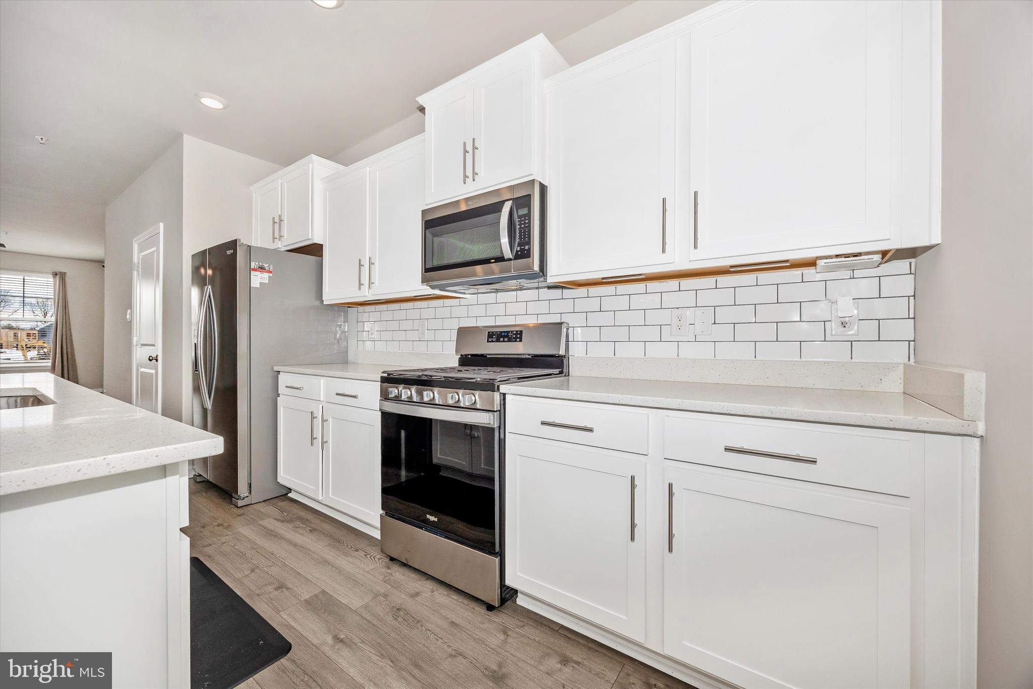 270 Ensemble Way Frederick, MD 21701 - Photo 18 of 43 a kitchen with white cabinets and stainless steel appliances