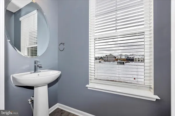 a bathroom with a sink a mirror and a window