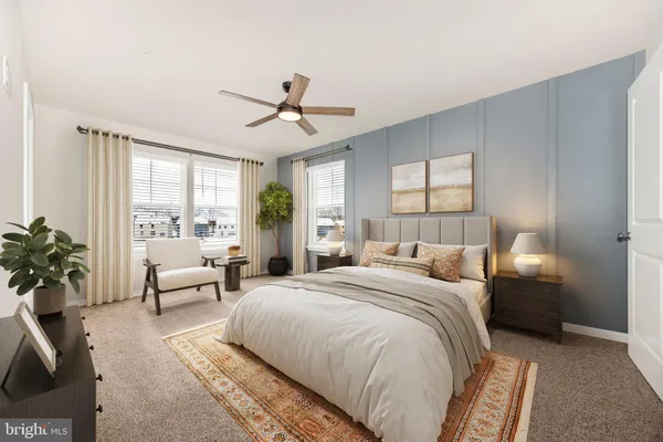 a spacious bedroom with a large bed and windows