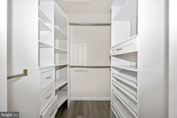 a view of walk in closet with empty racks
