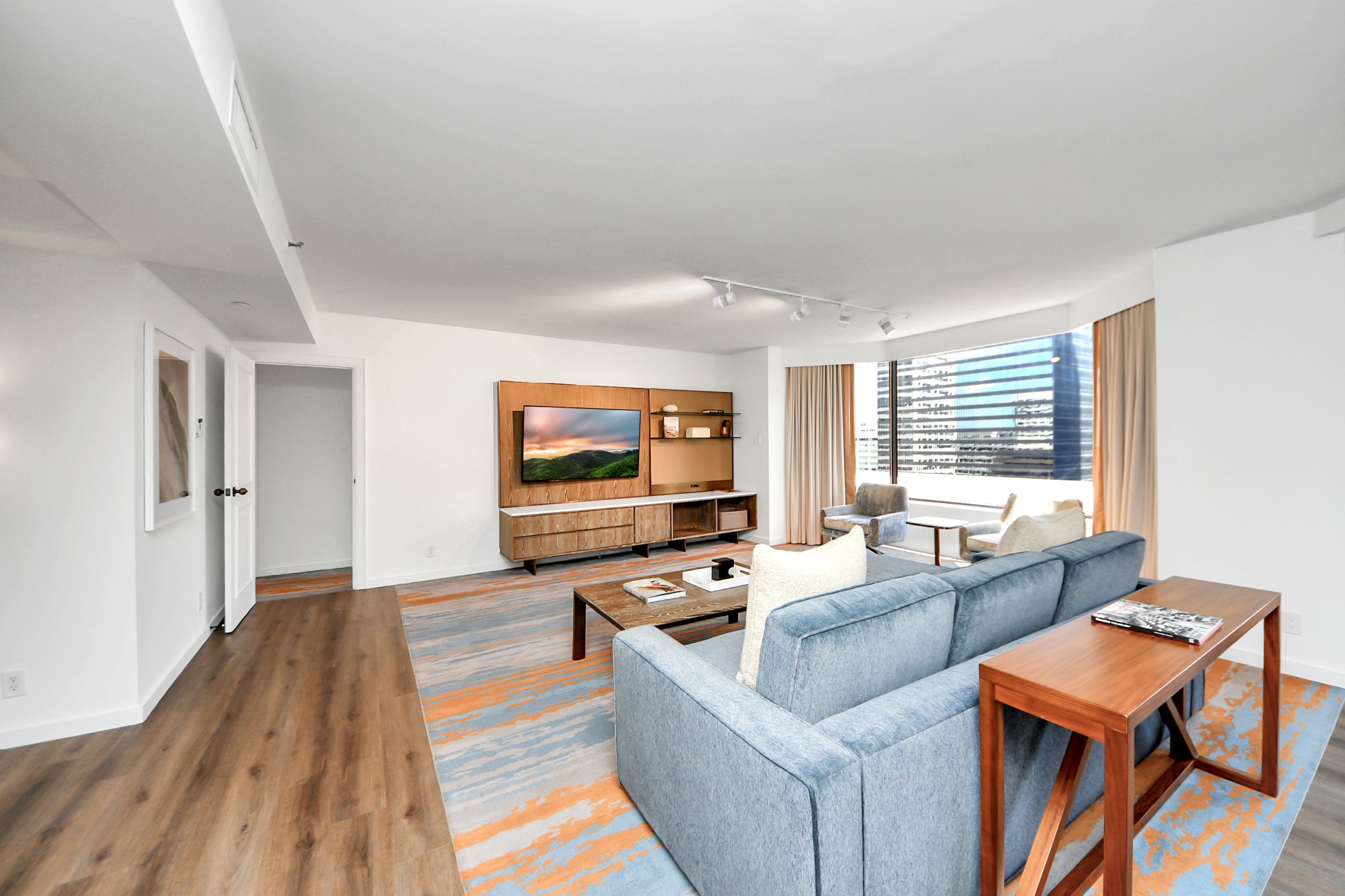 1300 Lamar Street, Unit S3 Houston, TX 77010 - Photo 7 of 50 a living room with furniture and a flat screen tv