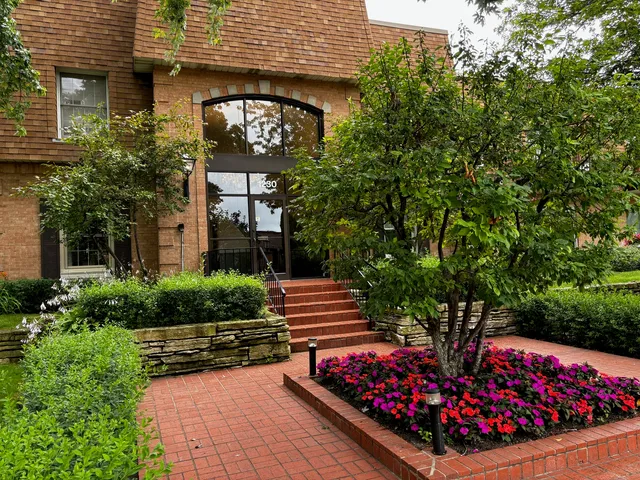 a sign that is sitting in front of flowers