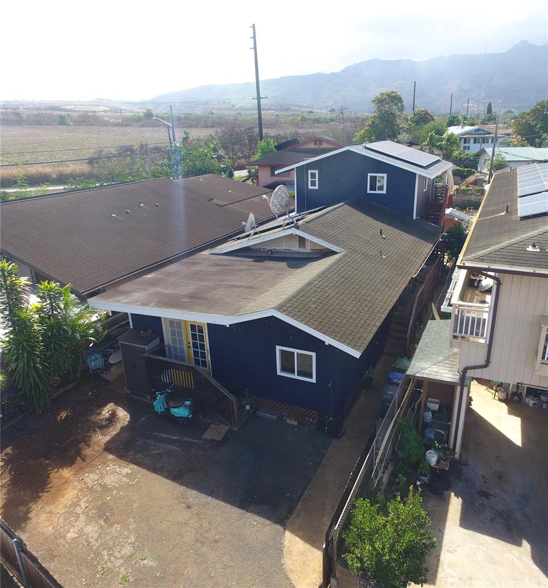 an aerial view of a house with a yard a table and chairs
