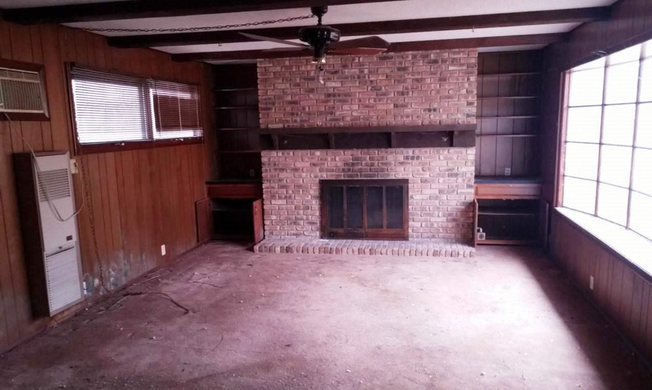 515 North 12th Street Rochelle, IL 61068 - Photo 3 of 4 an empty room with windows and fireplace