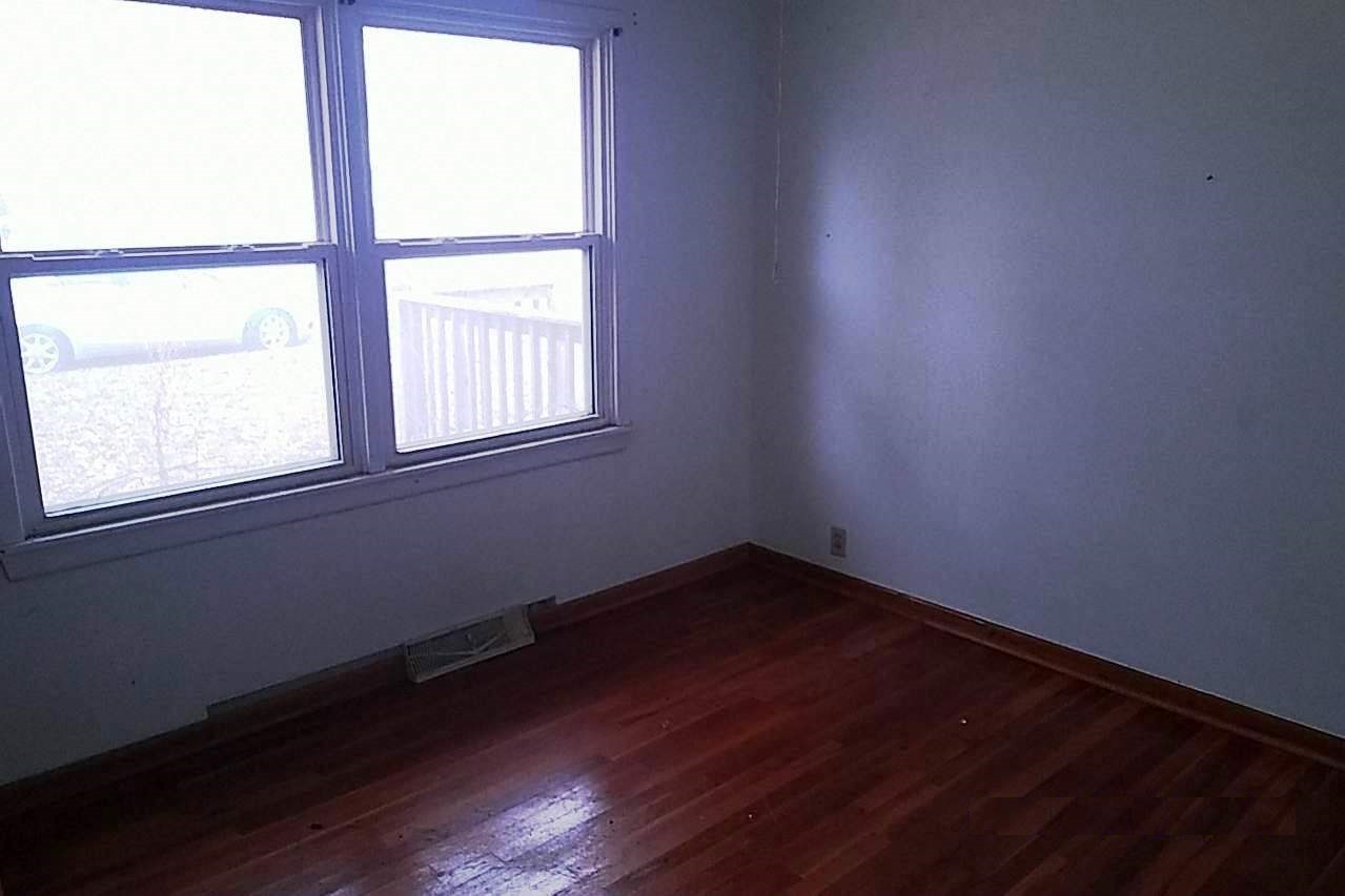 515 North 12th Street Rochelle, IL 61068 - Photo 4 of 4 an empty room with wooden floor and windows