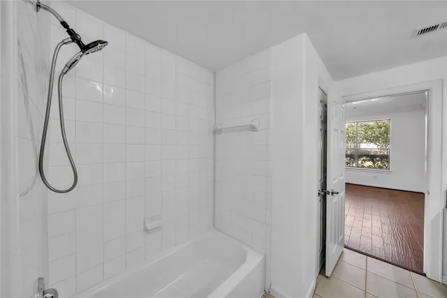 a bathroom with a glass shower door