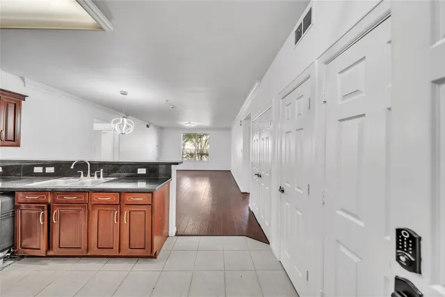 a kitchen with granite countertop a sink and cabinets