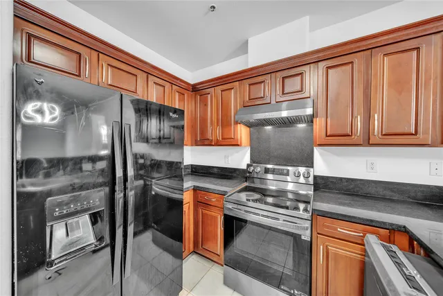 a kitchen with stainless steel appliances granite countertop a stove and a refrigerator