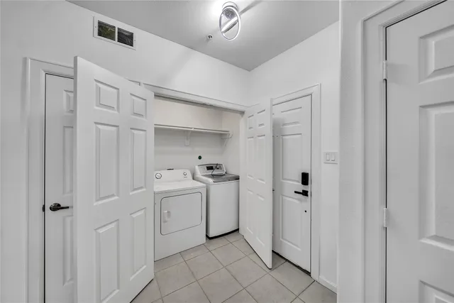 a view of a storage & utility room with closet empty racks