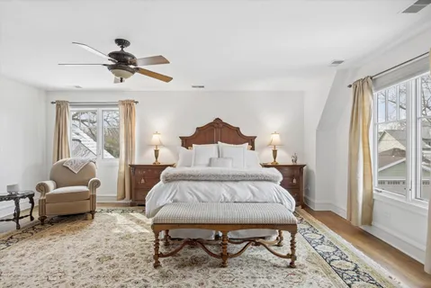 a bedroom with a bed and wooden floor