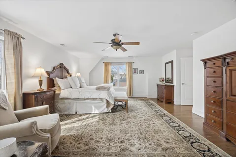 a living room with furniture a rug and white walls
