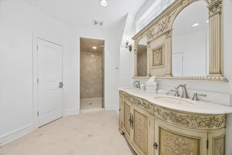 a spacious bathroom with a tub double vanity sink and a mirror