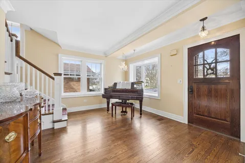 a view of a livingroom with furniture hardwood floor and windows