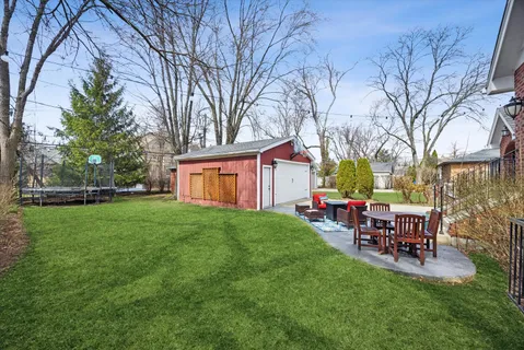 a view of a backyard with table and chairs and a fire pit