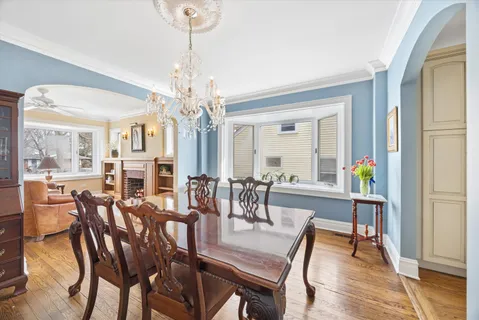 a view of a dining room with furniture wooden floor and chandelier