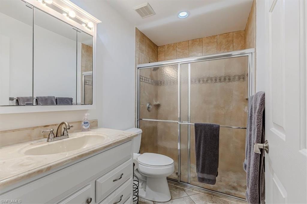 3609 Corinthian Way Naples, FL 34105 - Photo 11 of 23 Full bath featuring vanity, a shower stall, light tile patterned flooring, and recessed lighting
