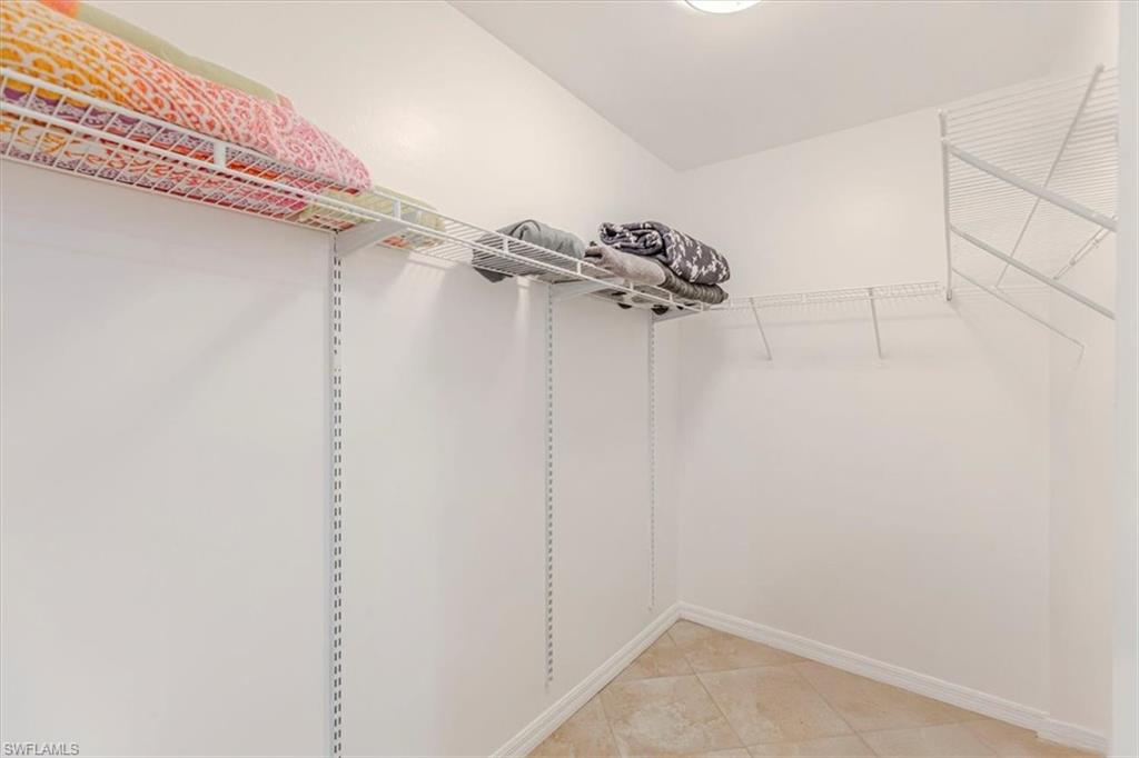 3609 Corinthian Way Naples, FL 34105 - Photo 20 of 23 Walk in closet featuring light tile patterned flooring