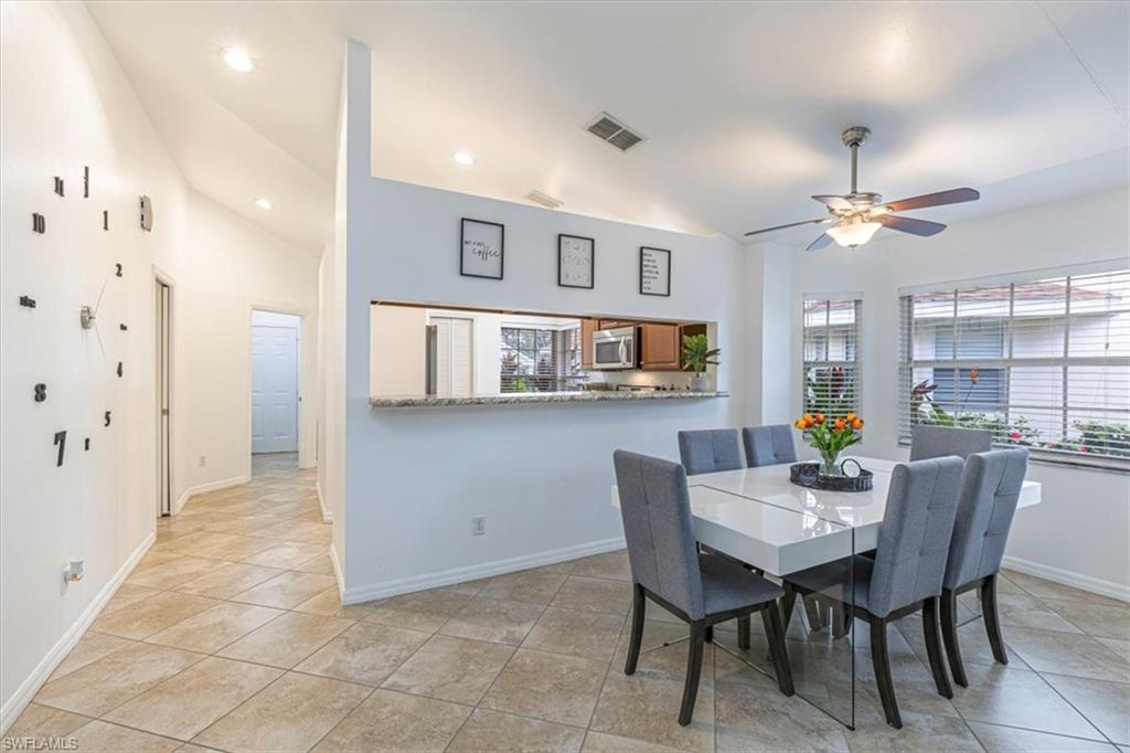 3609 Corinthian Way Naples, FL 34105 - Photo 9 of 23 Dining room with light tile patterned floors, a ceiling fan, recessed lighting, and high vaulted ceiling