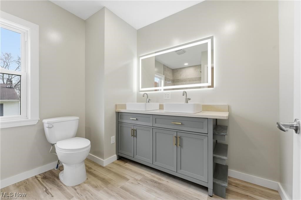 3793 Ranfield Road Kent, OH 44240 - Photo 22 of 40 Full bathroom featuring double vanity and light wood-style flooring