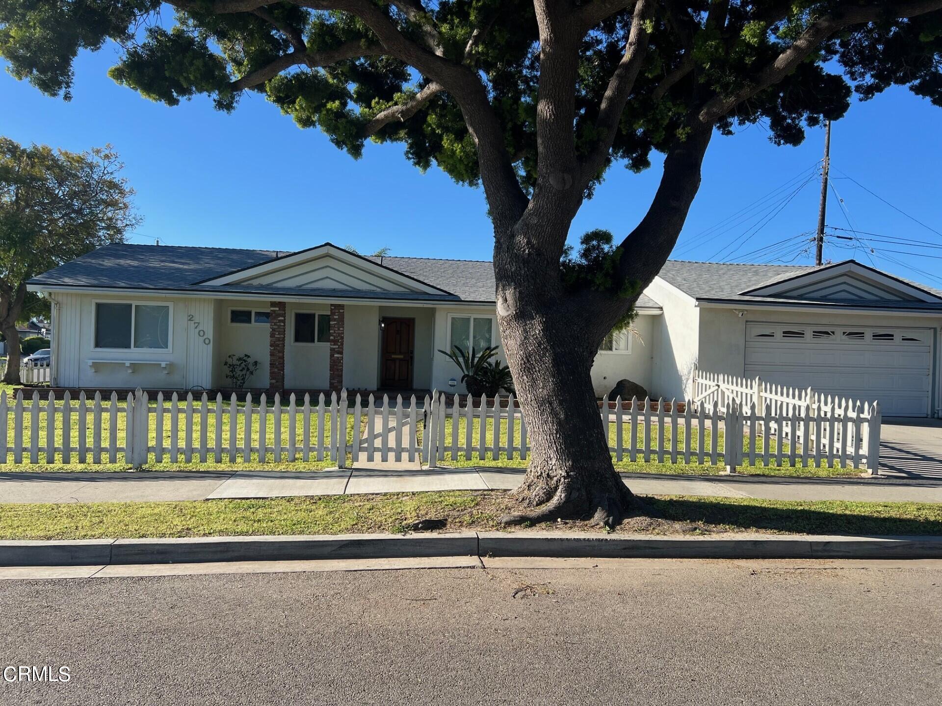a view of a house with a iron fence
