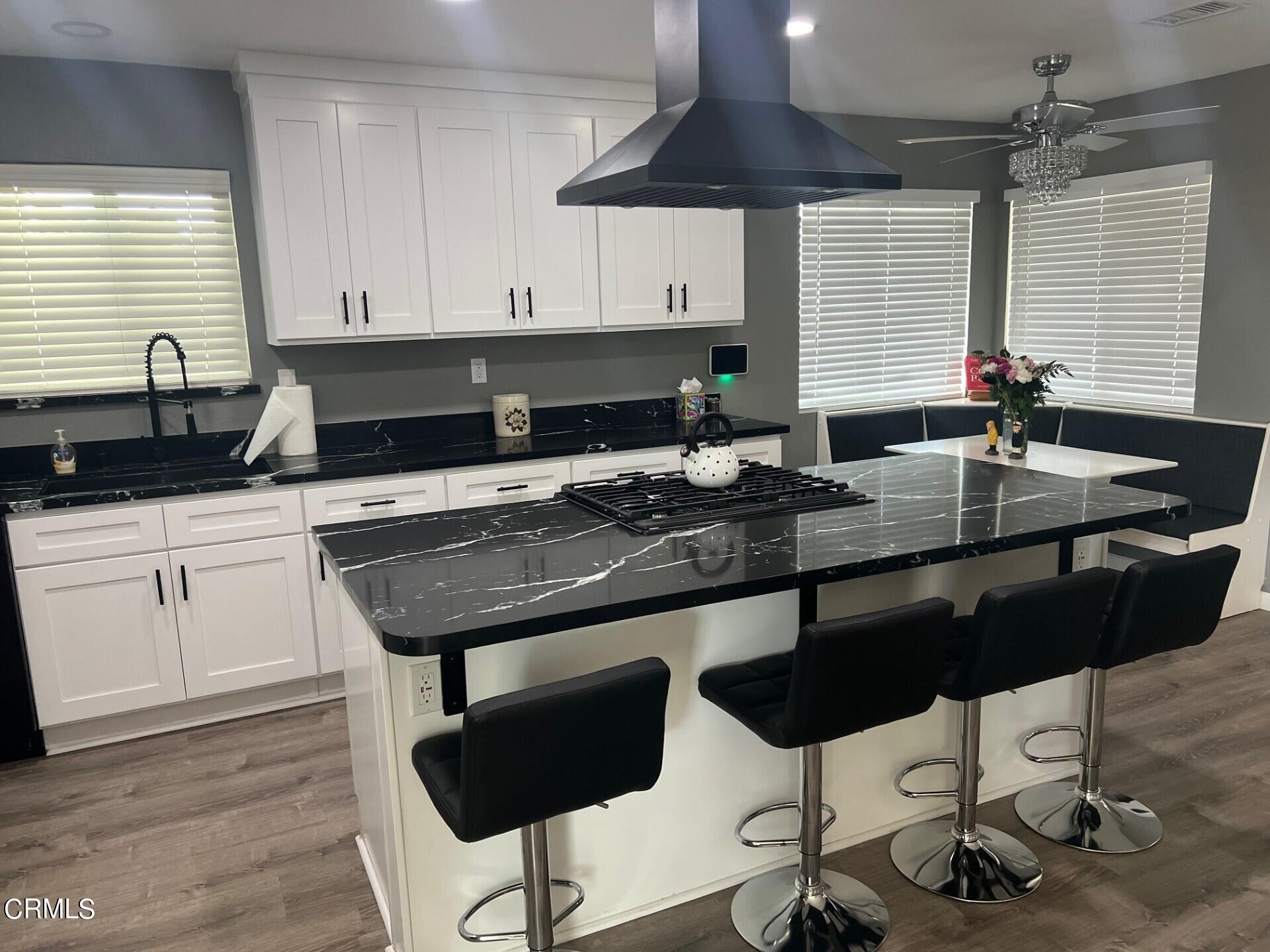 2700 Altus Way Oxnard, CA 93035 - Photo 5 of 10 a kitchen with granite countertop a sink a stove and cabinets
