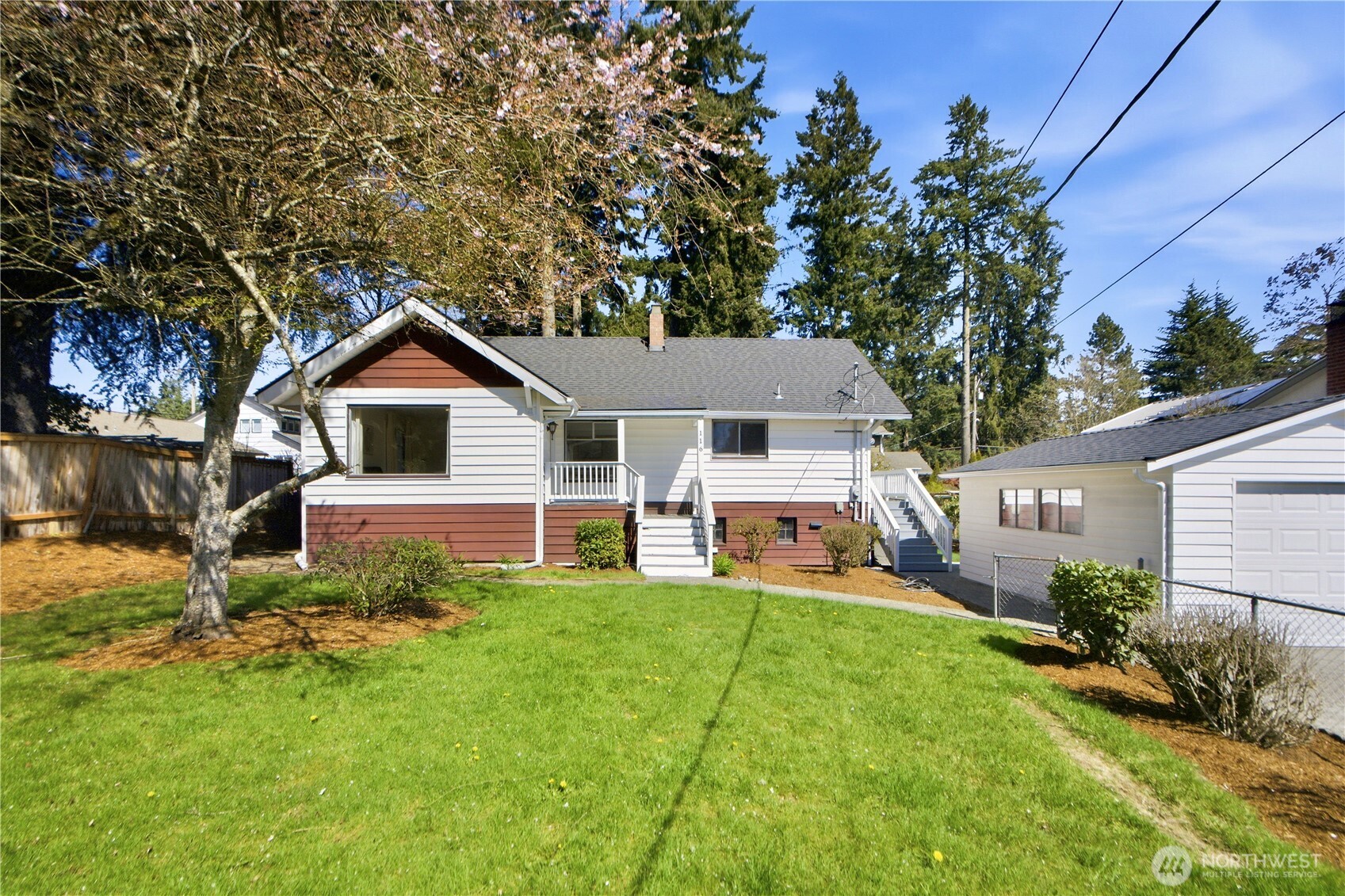 116 Northeast 133rd Street Seattle, WA 98125 - Photo 1 of 23 a front view of a house with a yard table and chairs