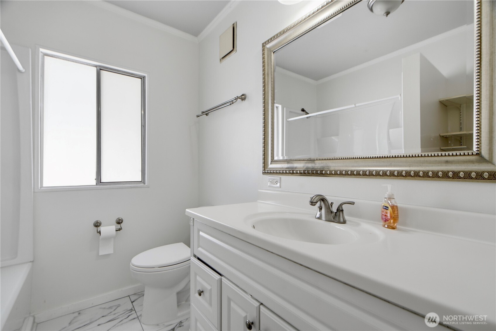 116 Northeast 133rd Street Seattle, WA 98125 - Photo 11 of 23 a bathroom with a sink a toilet and a mirror