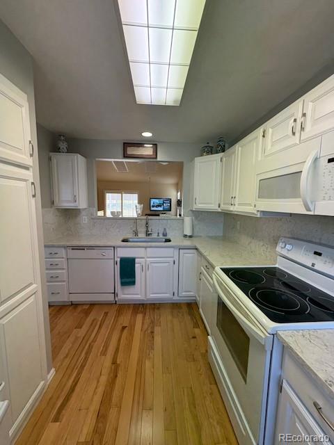 4 Shetland Court Highlands Ranch, CO 80130 - Photo 17 of 46 a kitchen with a sink a stove and cabinets
