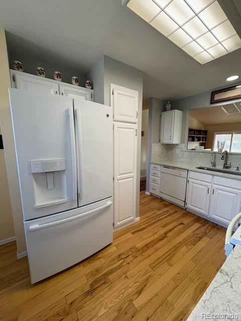 4 Shetland Court Highlands Ranch, CO 80130 - Photo 19 of 46 a kitchen with granite countertop a refrigerator and a sink