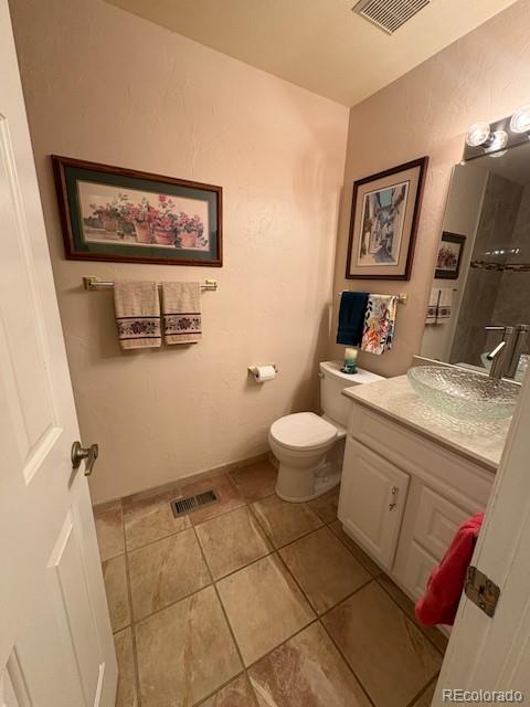 4 Shetland Court Highlands Ranch, CO 80130 - Photo 21 of 46 a bathroom with a toilet sink and mirror