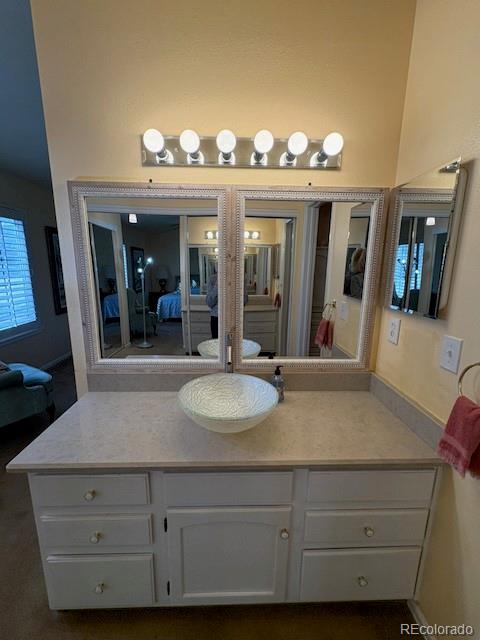 4 Shetland Court Highlands Ranch, CO 80130 - Photo 25 of 46 a bathroom with a sink and a mirror