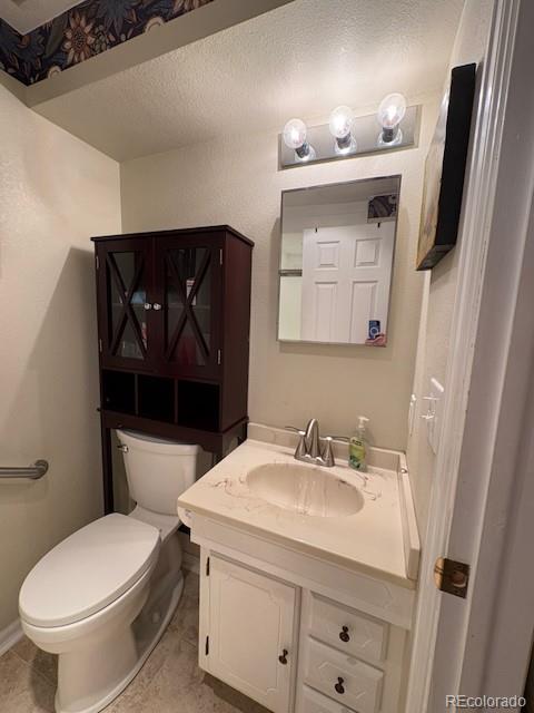 4 Shetland Court Highlands Ranch, CO 80130 - Photo 37 of 46 a bathroom with a toilet sink and mirror