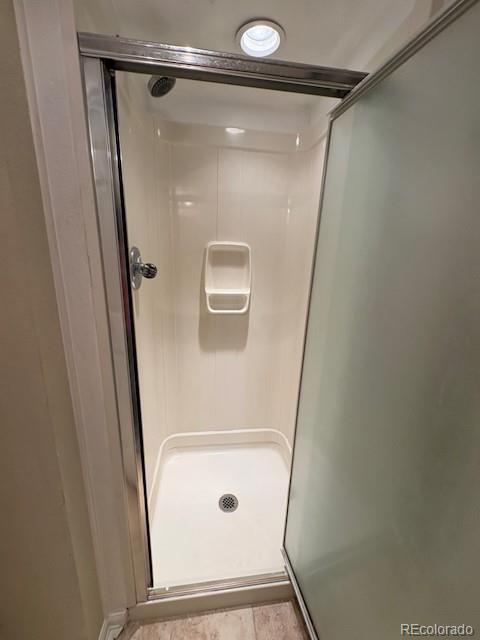4 Shetland Court Highlands Ranch, CO 80130 - Photo 38 of 46 a bathroom with a glass shower door and a window