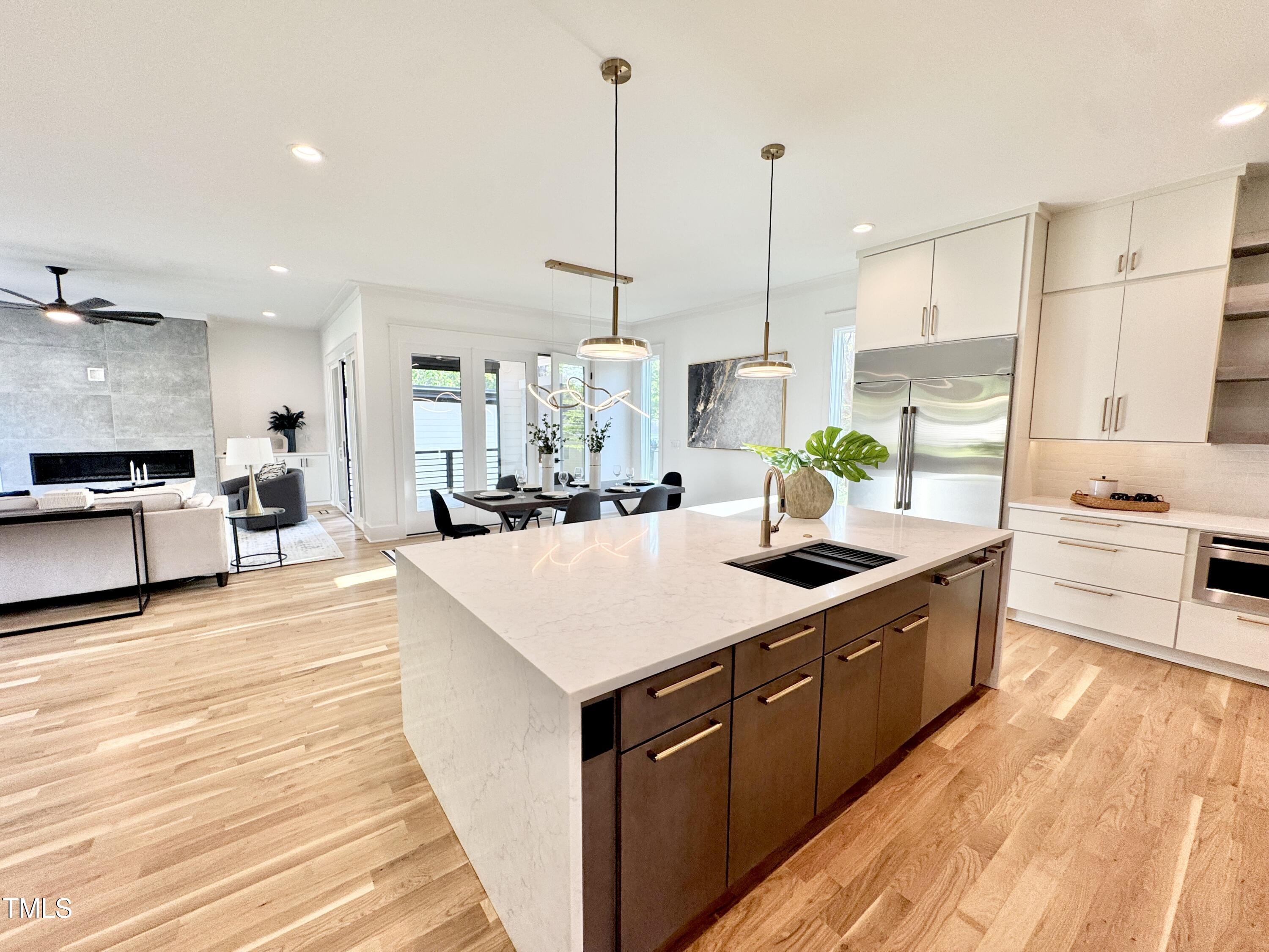 622 Glascock Street Raleigh, NC 27604 - Photo 16 of 81 a kitchen with kitchen island granite countertop a sink appliances and cabinets