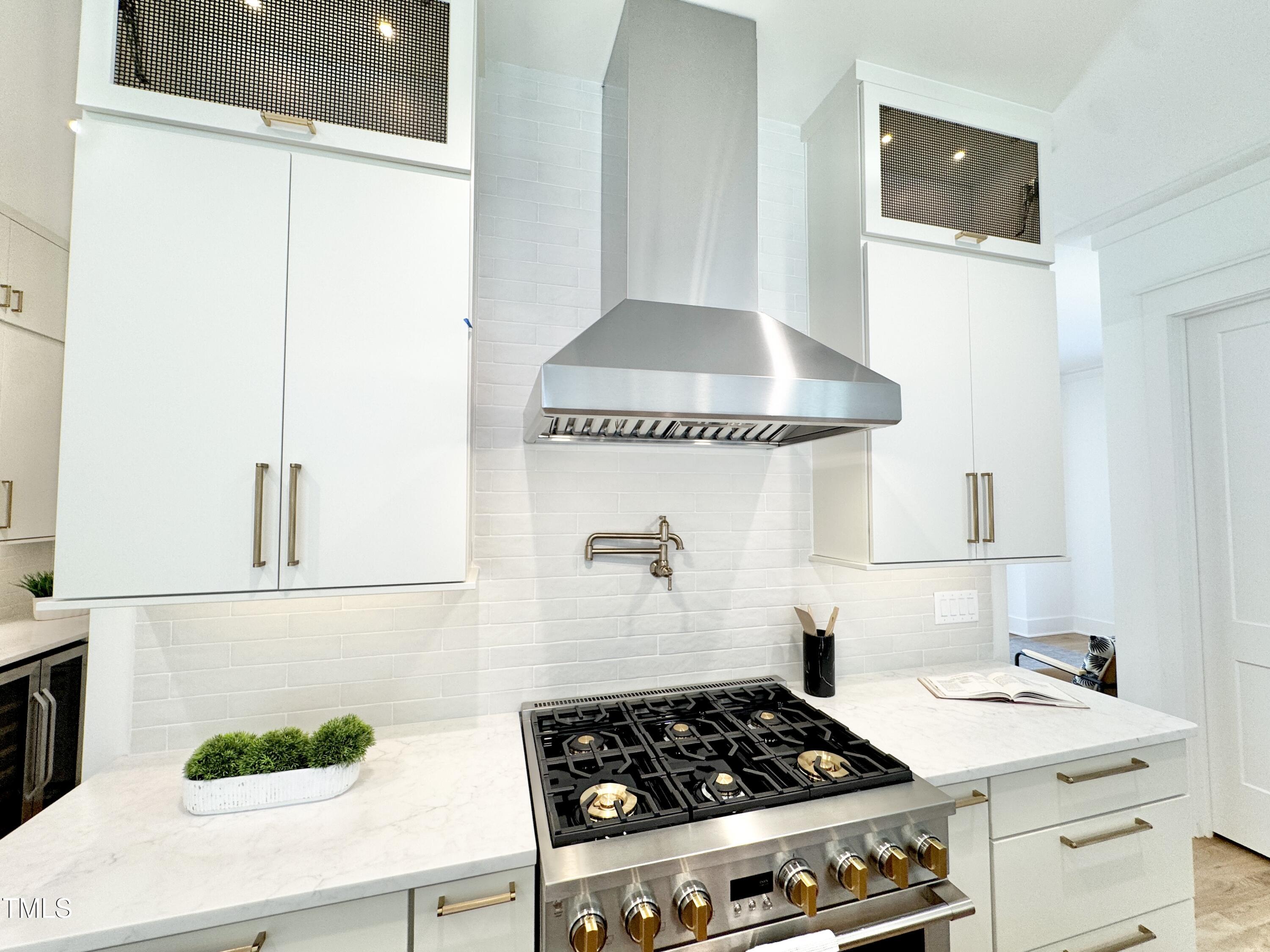 622 Glascock Street Raleigh, NC 27604 - Photo 24 of 81 a kitchen with a stove and white cabinet